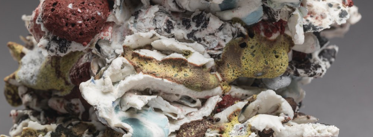detail of a ceramic sculpture featuring different colours and rough, jagged textures