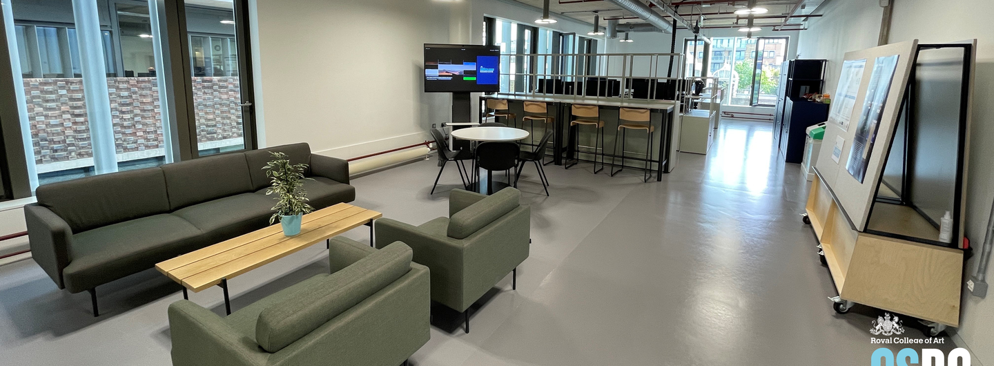 An office space with sofas and screens