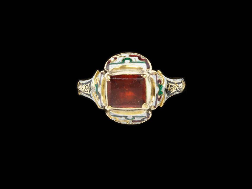 An ornate gold ring with a large central red gem from the V&A collection