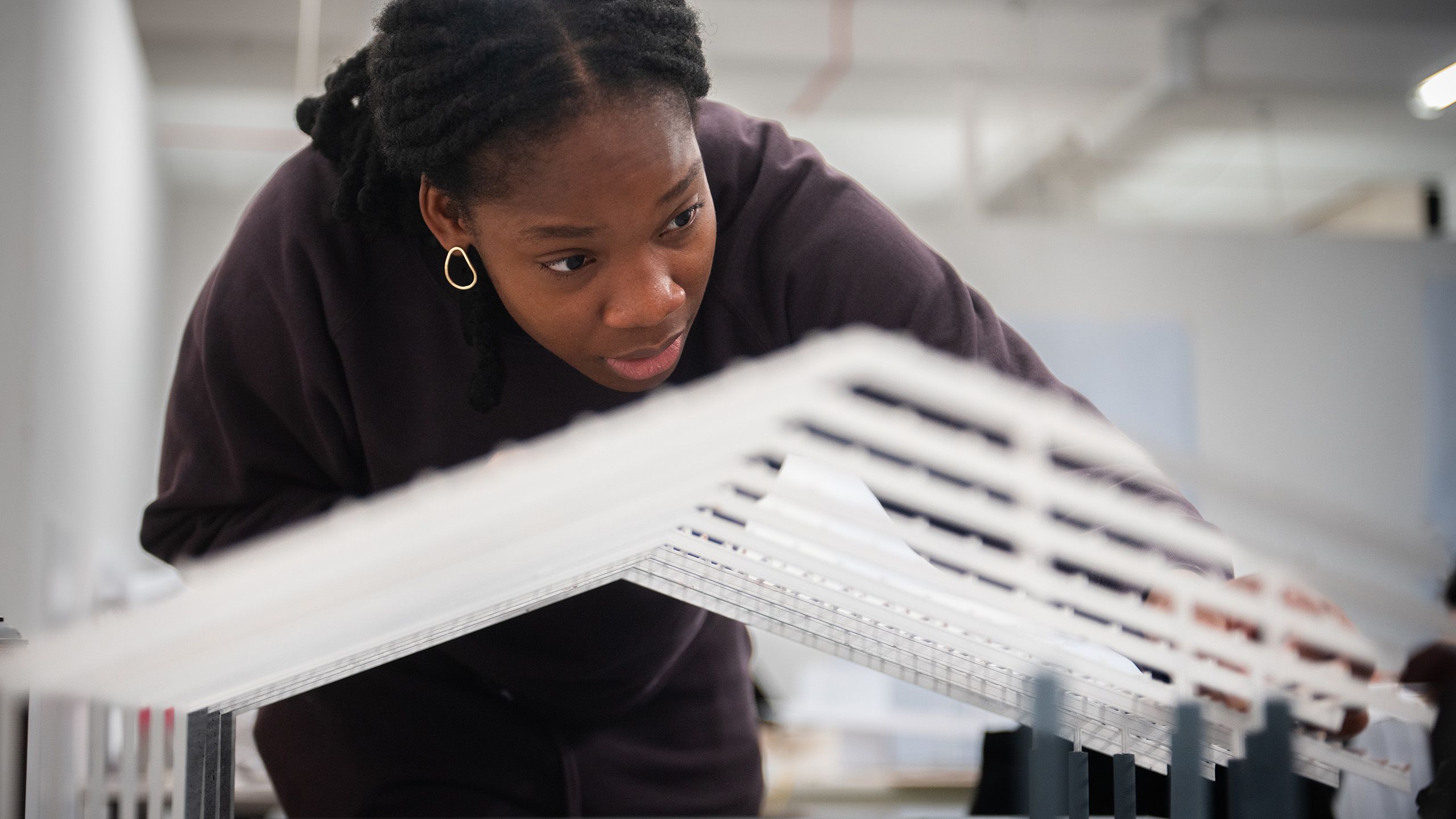 Close up of a student with an architectural model