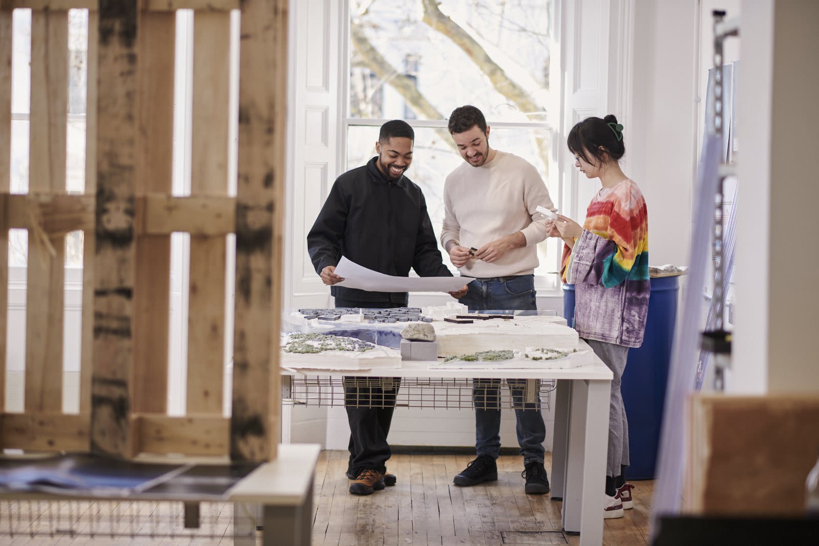 Three students look at a map