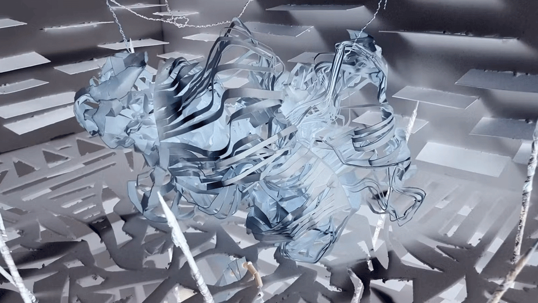 Abstract 3D sculpture with intertwined, ribbon-like shapes in a grey-toned environment with geometric patterns on the walls and floor.